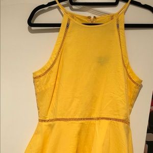 A-line halter yellow dress with “cut out” details along neckline, waist and edge